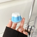 Detail of flower-shaped phone grip featuring a dual-layer white and sky blue design - Flower Shape / Double Color Jelly - Blue
