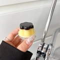 Macro detail of a dual-color pudding-style expandable phone grip with glossy finish - Pudding Shape / Double Color Jelly - Yellow
