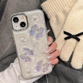 Detail of iPhone case with pearly butterfly and bow decor held in a gloved hand - Laser Bowknot (Electroplated Frame-White Glitter) / iPhone 7/8/SE 2020