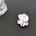 Detail of cute puppy phone grip with reflective mirror surface and pearl accent decoration - Purple