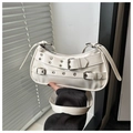 Close-up of white crescent crossbody bag with punk style silver buckles and eyelets - White