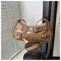 Detailed view of brown retro underarm bag with decorative metal buckle straps and rivets - Khaki