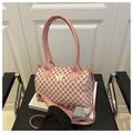 Close-up of pink pillow bag with vintage geometric patterns and butterfly metal buckle - Pink
