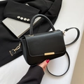 Minimalist black matte crossbody bag with gold hardware and stylish top handle design - Black