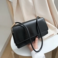 Black minimalist faux leather underarm bag with gold metal buckles and pleated sides - Black