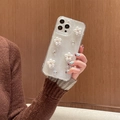 IPhone glitter transparent case with 3D pearl flowers and rhinestones held by a model - iPhone 7/8/SE 2020