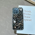 Detail showing luxury iPhone case with rhinestone bow, pearls, and panther motif charm - iPhone 7/8/SE 2020 / Black