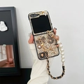Detail of glitter phone case for Z Flip with pearl handle and 3D metallic charms - Gold / Samsung ZFlip3