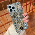 Luxury iPhone case detail featuring sparkling rhinestones, black bow, and pearl charms - iPhone 7/8/SE 2020 / White