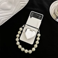 Detail of white cross-grain leather phone case with heart mirror and pearl strap - Bowknot Heart Mirror Bracket + Crackle Bead Chain / White / Samsung ZFlip6