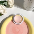 Close-up of iridescent crystal ball phone grip on a decorative ceramic plate with flowers - Magnetic Type - Crystal Glass - Rendering Pink