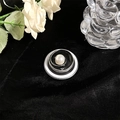 Macro shot of MagSafe phone grip with black and white resin swirl and central pearl detail - Metal Pearl Rose - Black