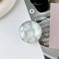 Detail of a round iridescent shell texture phone socket stand in green and purple hues - Transparent Type - Crystal Glass - Grey Shell Texture