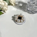 Detailed macro view of a floral MagSafe grip with white pearls and sparkling rhinestones - Gemstone Style 8 Round Pearl