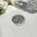 Detail of flower-shaped MagSafe phone grip with pink crystals and clear water drop stones - Gemstone Style 10 - Pink