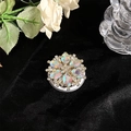 Detailed close-up of a flower MagSafe phone socket with opal-like rhinestones on black velvet - Large Full Rhinestone Iridescent Style 32