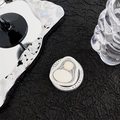 Primo piano di un supporto per telefono a forma di cuore su una superficie plissettata nera - Stile Piccolo Quadrato di Seta Senza Perle