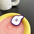 Macro detail of cute purple smiling face mirror phone socket on colorful tray - Deep purple