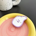 Detail of creative purple smiley face mirror phone grip on vibrant colorful table - Light Purple