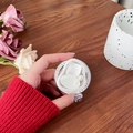 Detail of magnetic heart pearl phone socket held against a cozy autumn sweater - Irregular Ring Textured Square