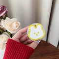 Close-up of a cute white rabbit phone socket holder held in hand against floral background - Magnetic Rabbit Holder - Yellow