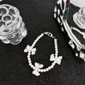 Detailed shot of white pearl phone strap featuring three elegant ribbon bow charms - Three Bowknot Pearl Short Chain