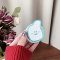 Close-up of cute cloud-shaped phone grip with smiling face held by hand on desk - Light Green