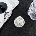 Detailed shot of holographic heart phone grip with Gift For You print on black texture - Ruched Heart Style