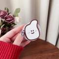 Close-up of a cute banana mirror phone grip featuring a white smile face on a gift card - Brown