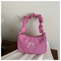 Detalle de bolso rosa plisado con bordado de lazo blanco y diseño elegante de estilo hobo - rosa intenso