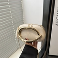 Chic beige oval evening clutch with wide gold C-shaped handle and slim chain strap - White