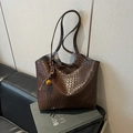 Large dark brown woven tote bag with metallic ball charm shown on a sofa - Coffee (With Bell Rope Charm)