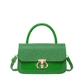 Green crossbody square bag featuring a textured woven flap and gold metal twist lock - Green