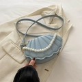 Light blue shell-shaped crossbody bag with faux leather quilting and pearl chain strap - Blue
