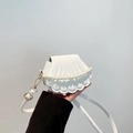 White shell-shaped crossbody bag with quilted texture and decorative white pearls - White