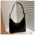 Detailed close-up of a black minimalist hobo bag featuring a matte finish and silver buckle - Black