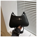 Detail of black woven shoulder bag featuring a silver star metal buckle and braided handle - Black