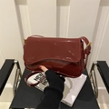 Glossy red patent leather shoulder bag with flap closure and gold buckle detail - Red