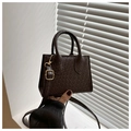Detail of dark brown woven texture handbag with golden hardware and double handles - Dark Brown