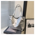 Detail of silver metallic tote bag with adjustable buckle strap and fine leather texture - Silver