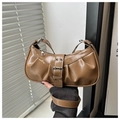 Macro detail of brown pleated leather surface with metallic buckle and silver eyelets - Khaki