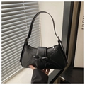 Close-up of black baguette underarm bag with decorative bow and sleek zipper closure - Black