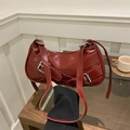 Deep red crescent underarm bag with decorative belt buckles in polished PU leather finish - Red