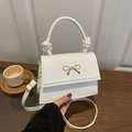 Elegant white bow crossbody bag with gold hardware and stylish knotted handle detail - White