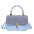 Light blue crossbody bag with textured flap and golden hardware on a white background - Blue