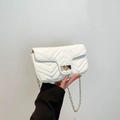 White quilted crossbody bag with chevron stitching, gold chain strap and turn-lock closure - White