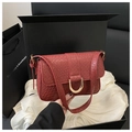 Detail of red woven texture flap bag featuring a golden D-shaped metal buckle and strap - Red