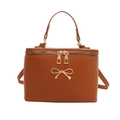 Brown box-shaped vanity handbag with gold bow detail and matte leather finish - Brown