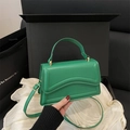 Minimalist green faux leather handbag with wavy stitching and gold metal hardware - Green