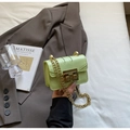 Detail of light green patent leather mini bag with gold chain strap and metal lock - Green